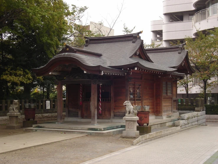 an old, rustic shrine building on a city street