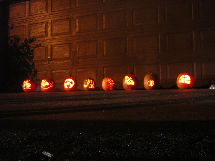 some pumpkins with faces carved into them outside