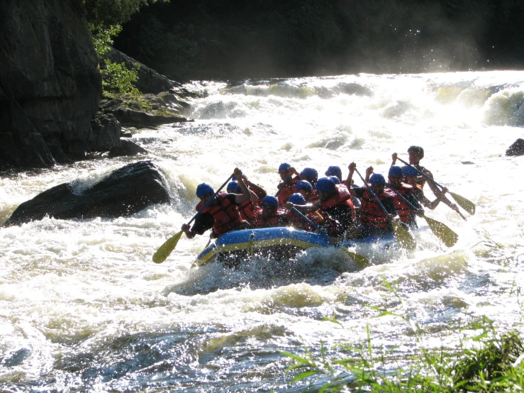 a group of people on a raft are in the water