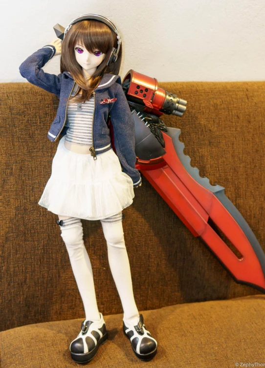 a doll with an orange tool holding a blue coat over her head