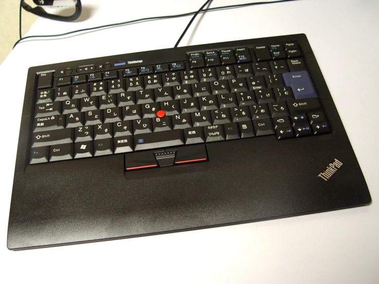 a black computer keyboard sitting on a white surface