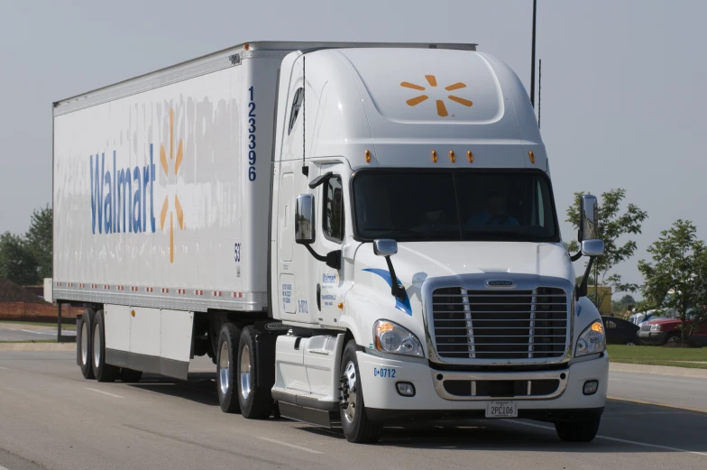 the front of a tractor trailer truck traveling down a street