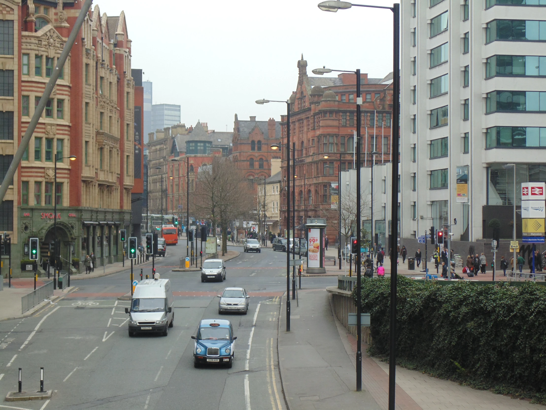 street with cars moving on the street and tall buildings