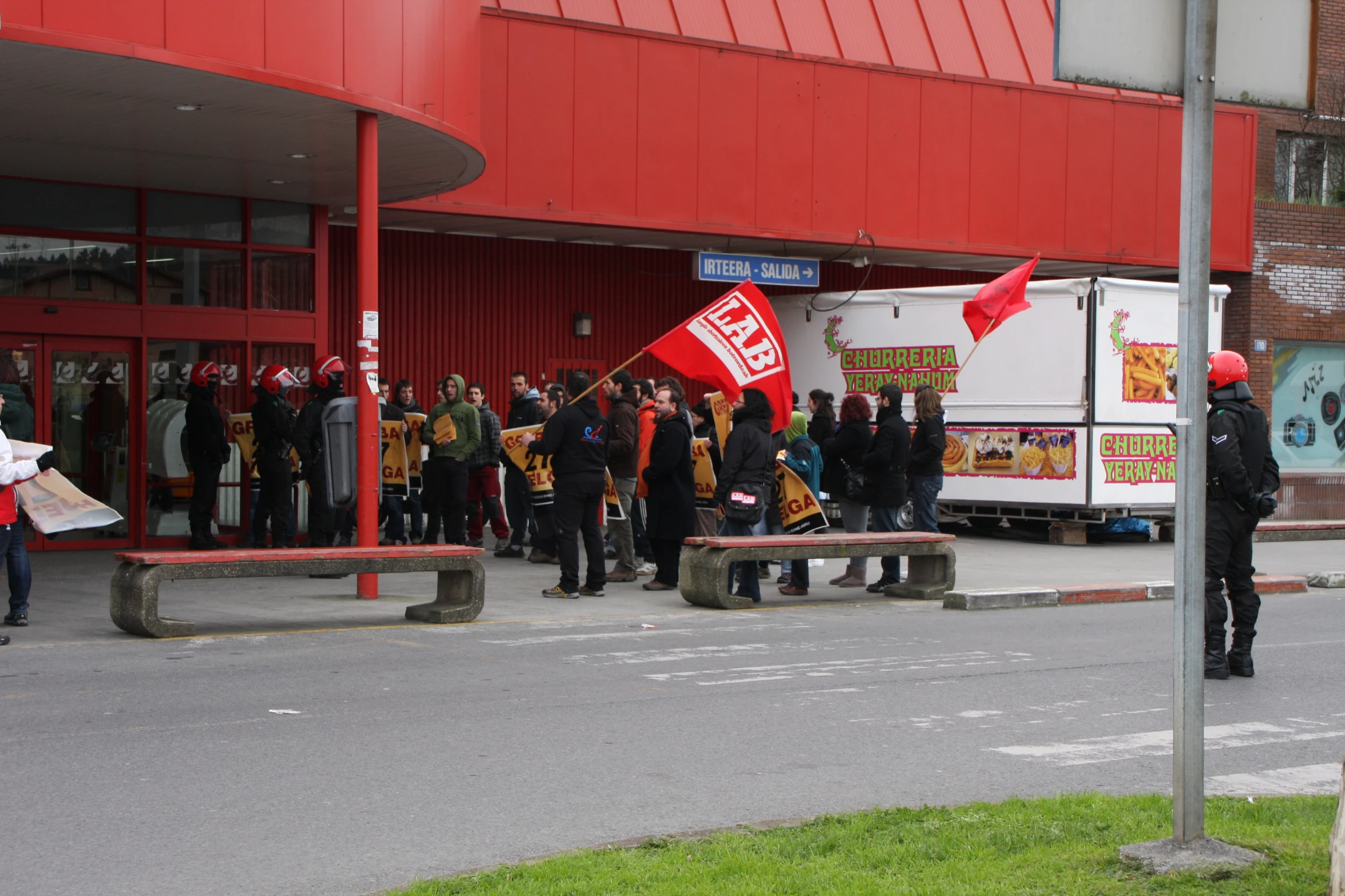 a number of protesters standing on the street with signs