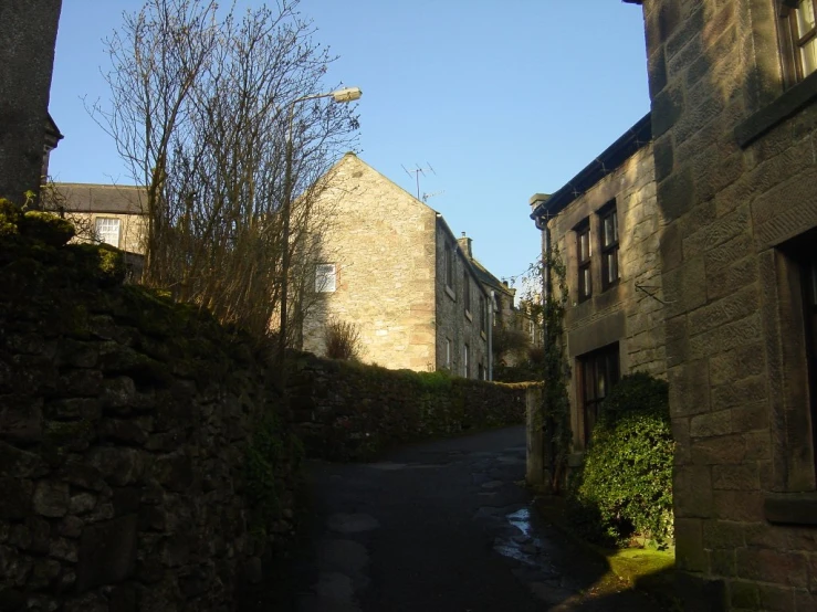 a street with an older building on one side and a street light above it