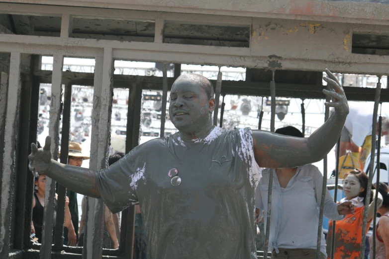 people gathered around a concrete statue being built