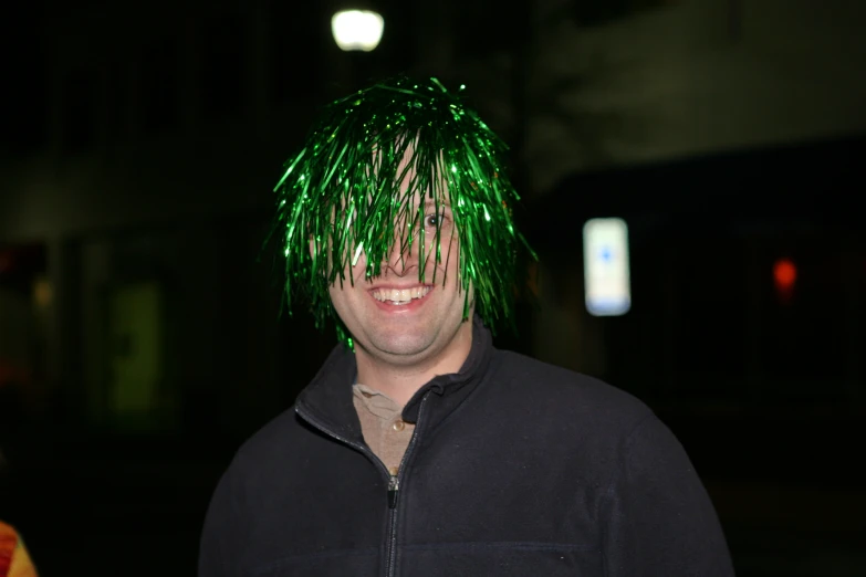 a man has green colored hair and a smile