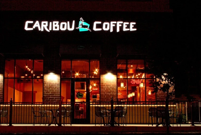 caribou coffee at night lit up in bright neon lights