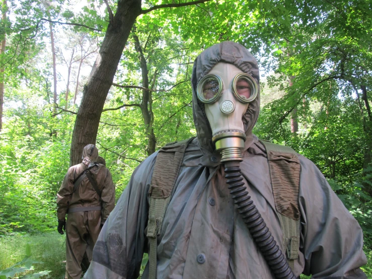 man with gas mask on wearing jacket in forest