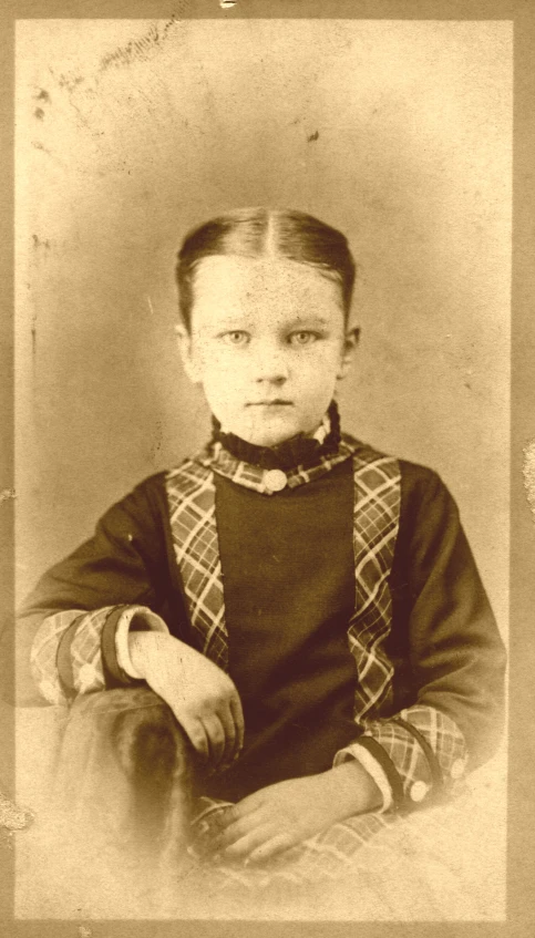 an old pograph of a boy in a shirt and bow tie