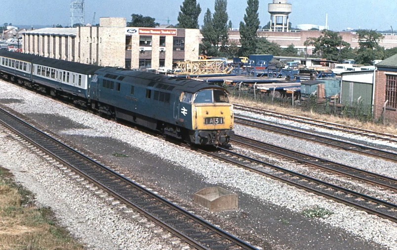 a train traveling down train tracks next to a building