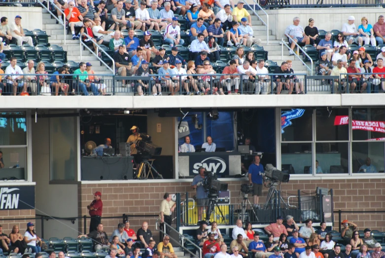 baseball stadium with audience of fans watching batter practice his swing