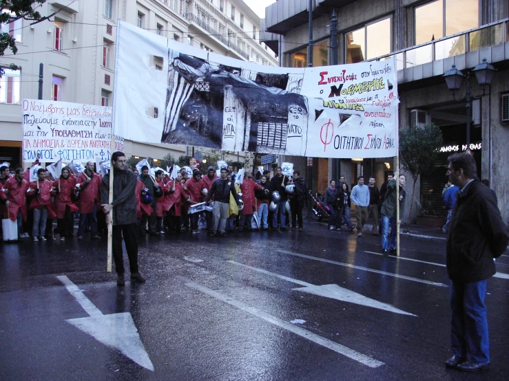 there are people protesting on the street holding up signs