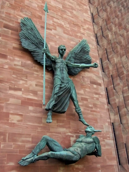 a statue is mounted on the side of a building