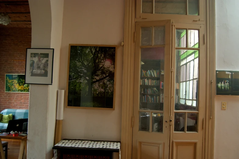 a window with bookshelves next to it in front of a door