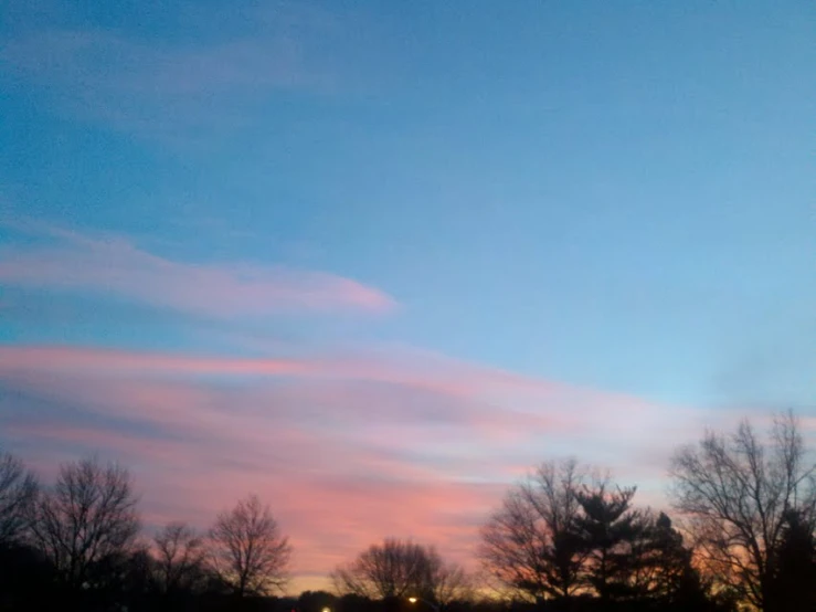 a pink and blue sky filled with light at dusk