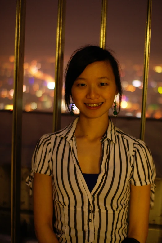 a woman with a striped shirt looks up at the camera