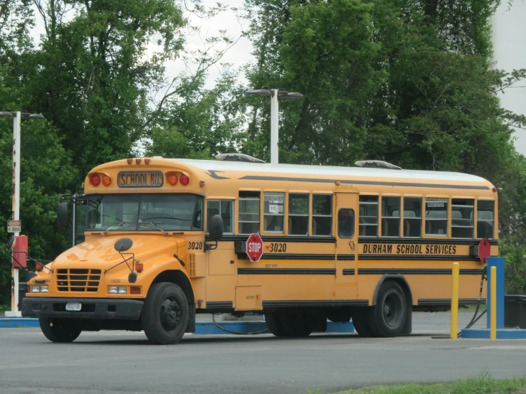 a yellow bus is parked in a parking lot