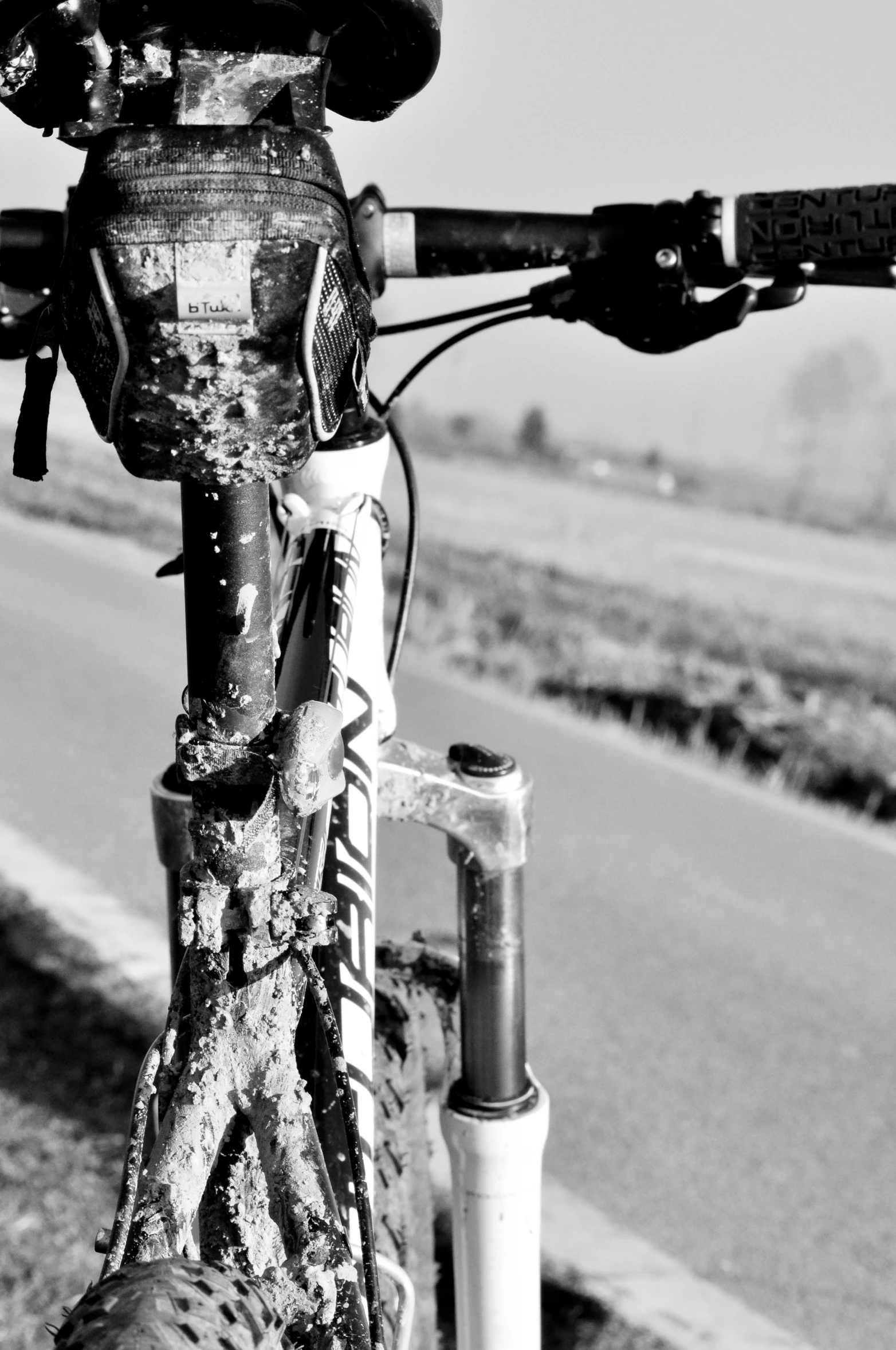 a bike on the side of the road next to a pole