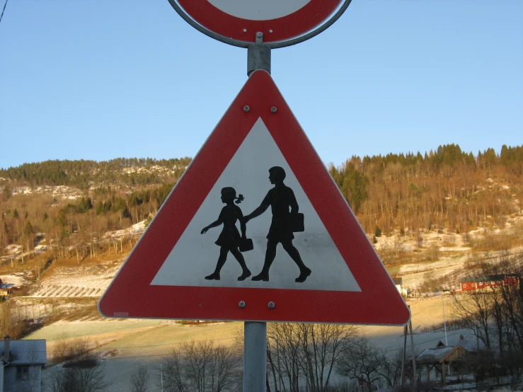 a street sign warning of people crossing the road