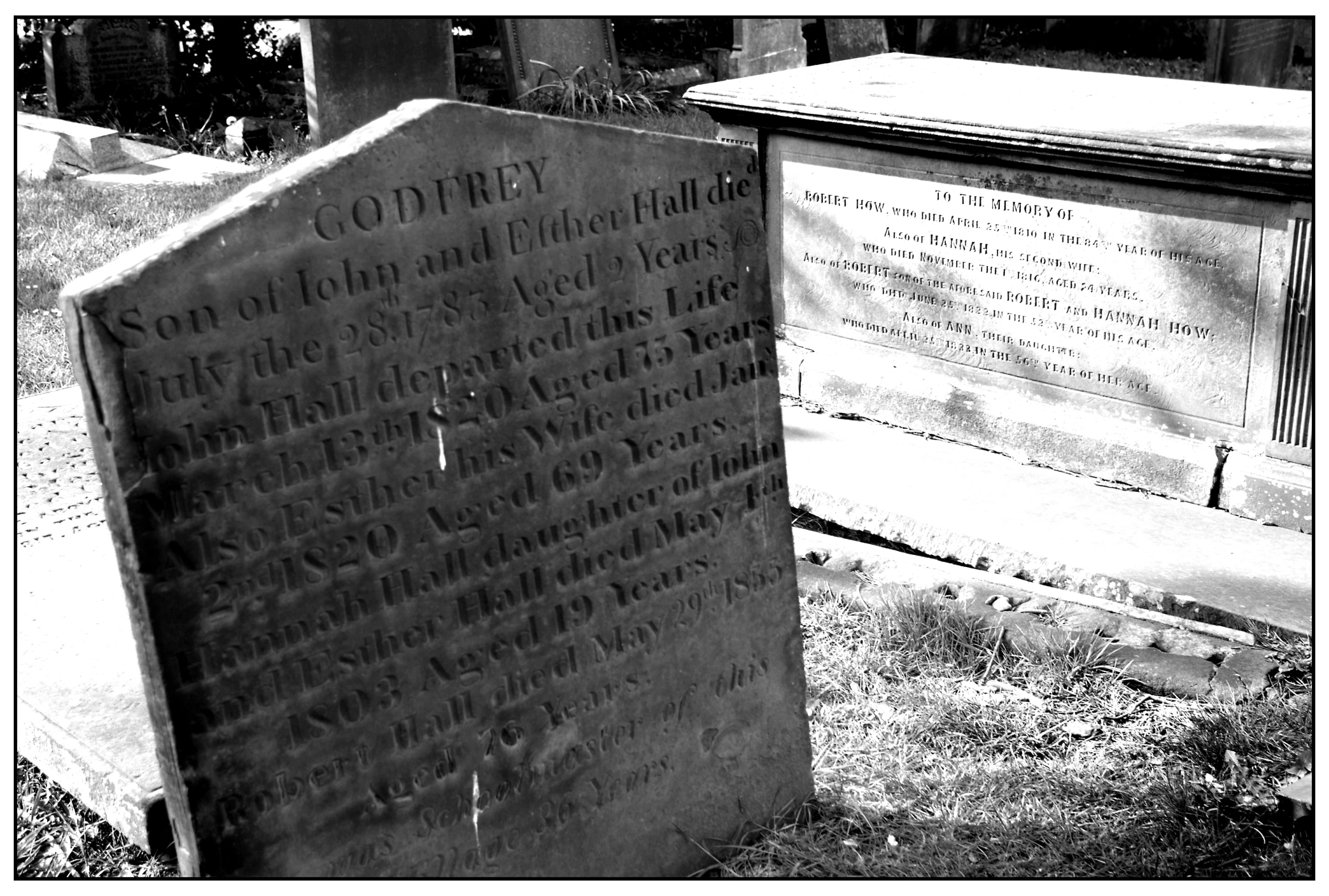 a memorial sitting in front of a grave on the ground