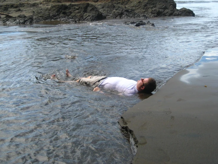 a woman swims through the water with a frisbee