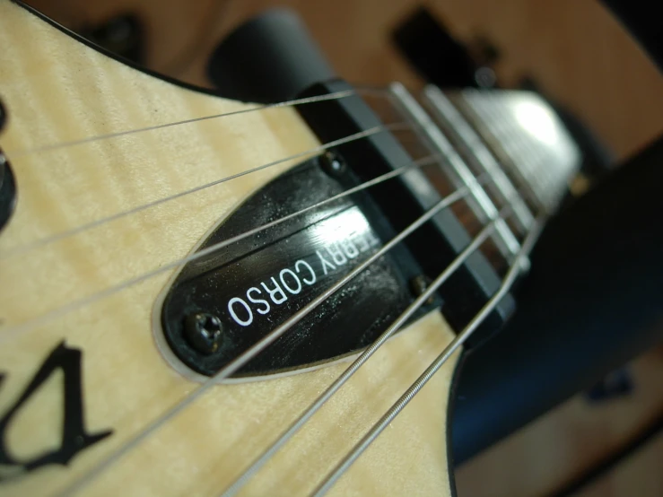 a bass is placed on a guitar with black strings