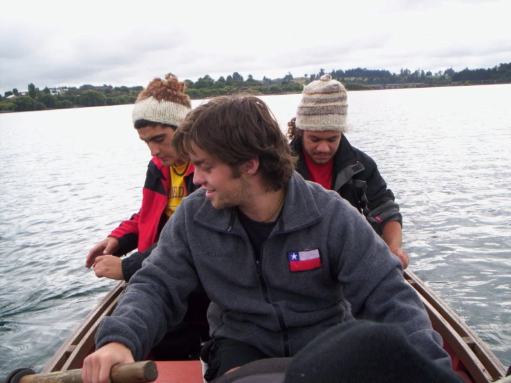 four people in a row boat in the water