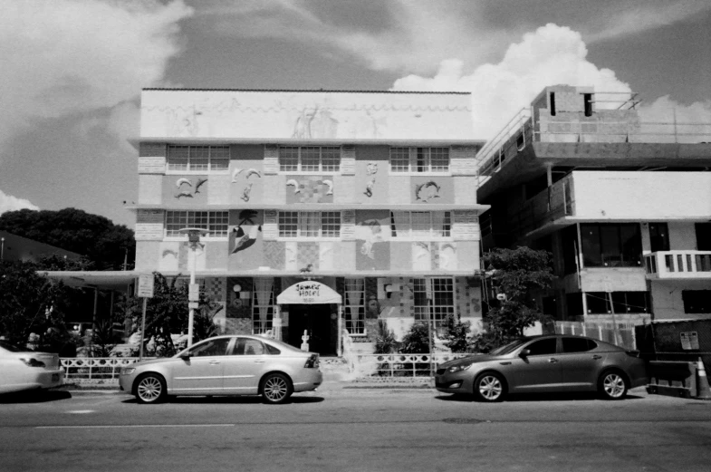 an old building with many windows and cars