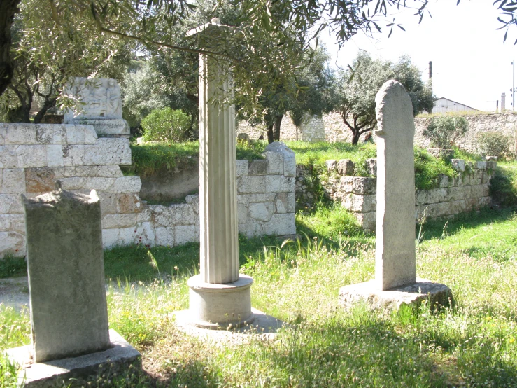 ancient stone structures sit in a grassy area