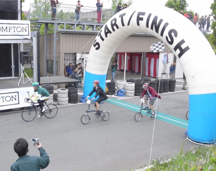 the start line is lined with bicyclists, and people riding their bikes