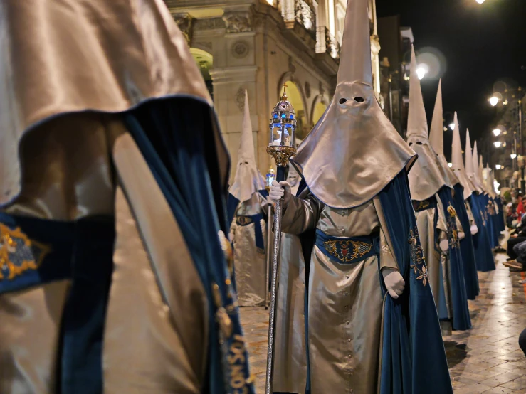 a group of people wearing costume and holding items