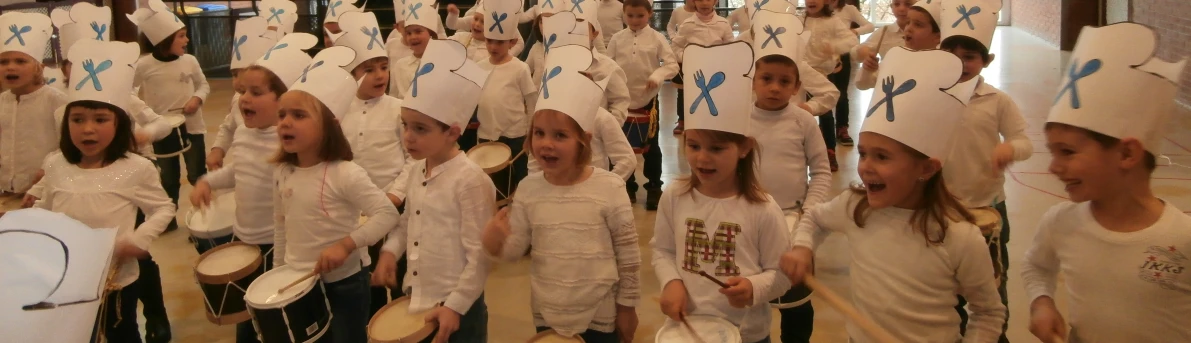 young s with paper hats are standing in a row