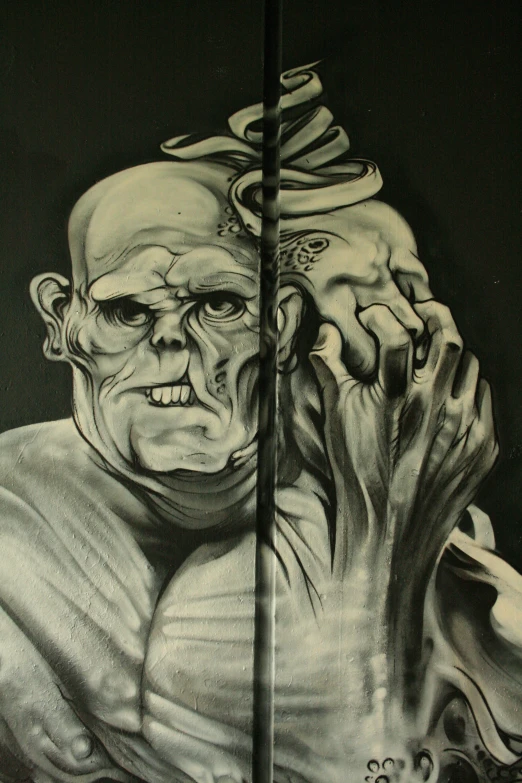 a large black and white painting of an old man with his hands in his face