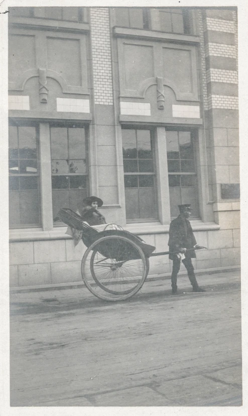 an old black and white po with a man hing a horse drawn carriage