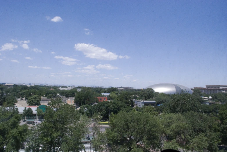 a big dome and buildings with trees around it