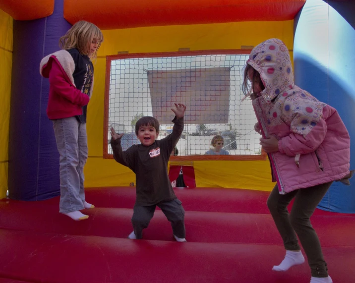 a girl and her brother on a jumping obstacle