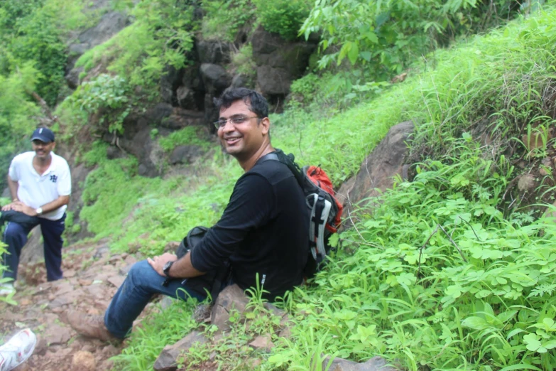 a man on a rocky path with a backpack