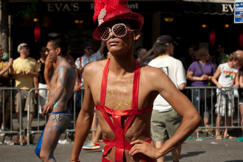 a man wearing glasses and a red outfit