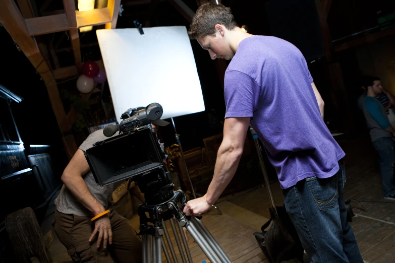 a group of people standing around a video set