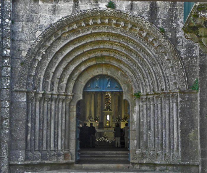 a church with arches and doorway leading to the entrance