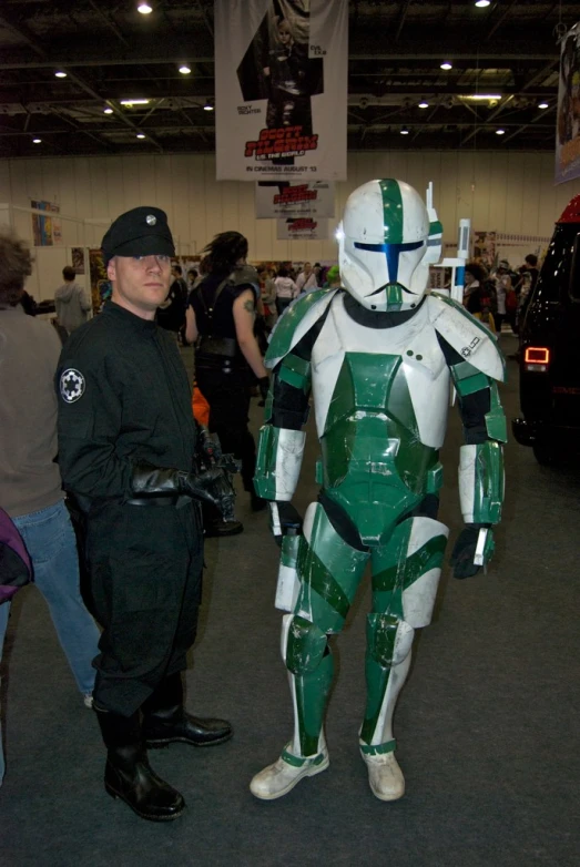 a guy in a costume standing next to an adult star wars trooper