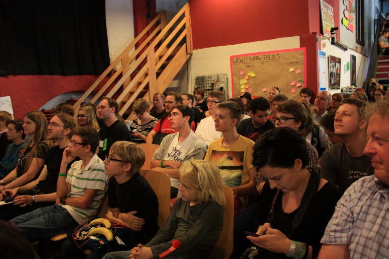 many people are sitting in a lecture hall