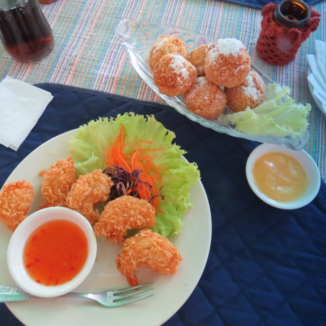 this is two plates filled with food, one is crab cake and the other is soup