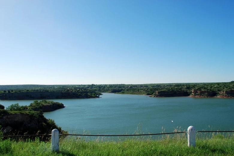 a large body of water with a forest in the background