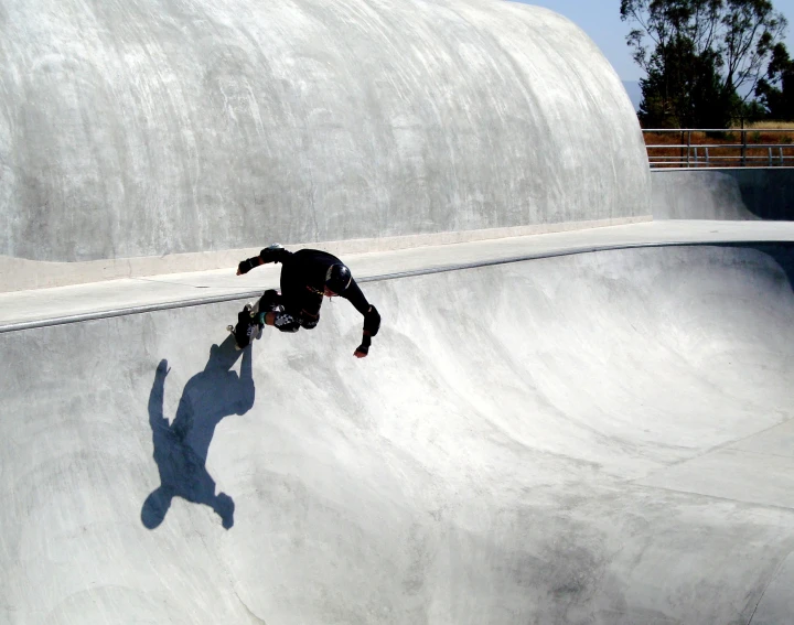 a man riding his skateboard down the side of a ramp