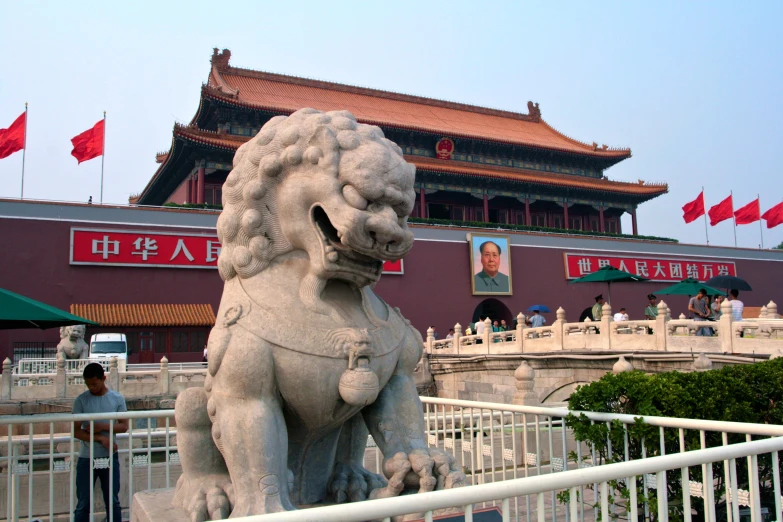 an oriental building in china is surrounded by large statues