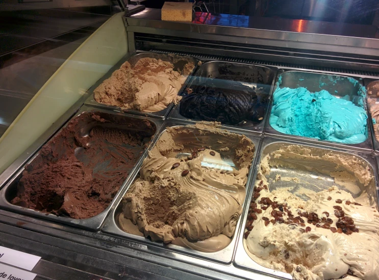 an assortment of various desserts are in ice cream display cases