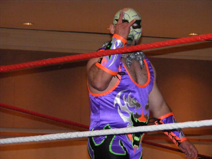 a wrestler wearing an orange and green uniform