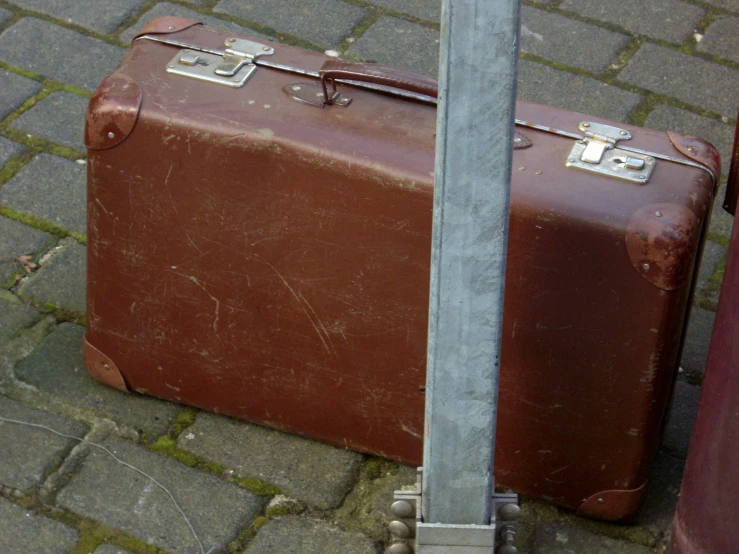 two old luggage sets on the street next to each other